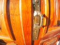 Old bronze door handle close-up on a wooden red door