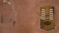 Old bronze intercom on an old wall with peeling paint. Ratio 16:9 Royalty Free Stock Photo