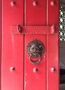 Old bronze knocker with red door Royalty Free Stock Photo