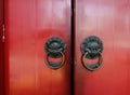 Old bronze knocker with red door Royalty Free Stock Photo