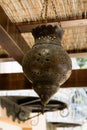 Old bronze lamp under a bamboo canopy Royalty Free Stock Photo