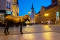 Old bronze sculpture of a donkey on the street in the historical district of Torun