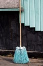 An old broom against the old wall