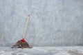Old broom on grungy concrete wall Royalty Free Stock Photo