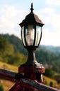 Old brown beautiful decorated wooden street lamp Royalty Free Stock Photo