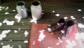 Old brown boots on red door mat and two vintage aluminum milk cans on wooden floor Royalty Free Stock Photo