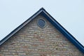 Old brown brick loft with one gray round window Royalty Free Stock Photo