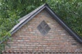 Old brown brick loft with a small one gray window Royalty Free Stock Photo