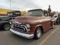 Old brown 1957 Chevrolet 3100 pickup truck Task Force step-side bed in the parking lot. Royalty Free Stock Photo