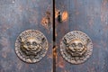 Old brown chinese traditional wooden gate with Lion door knocker Royalty Free Stock Photo