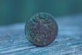 Old brown copper coin with an eagle on a gray table Royalty Free Stock Photo