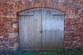 Old brown double doors with an arched top on a barn in Dunster in Somerset, England Royalty Free Stock Photo