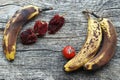 Old brown dried bananas, peppers and tomatoes on a wooden base