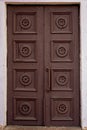 Old brown house door. Wooden vintage building gate weathered. Closed doorway.