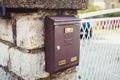 Old brown metallic retro post box on wall Royalty Free Stock Photo