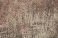 An old brown painted wall background. A plaster wall texture with rough scratches. Royalty Free Stock Photo