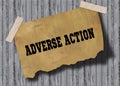 Old brown paper with ADVERSE ACTION text on wooden background.