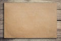 Old brown paper on grunge wood background and texture with space Royalty Free Stock Photo