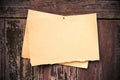 Old brown paper on wood board background Royalty Free Stock Photo