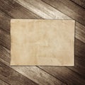 Old brown paper on wooden wall background for texture Royalty Free Stock Photo