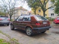 Old brown popular veteran classic compact car Volkswagen Golf II parked