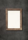 Old brown rustic wooden picture frame hanging on a concrete wall Royalty Free Stock Photo