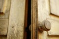 Old brown shabby wooden door with a round knob Royalty Free Stock Photo