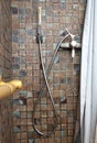 Old brown shower with a curtain