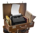 Old brown suitcases with old retro typing machine on white background