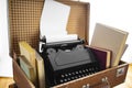 Old brown suitcases with old retro typing machine on white background