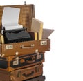 Old brown suitcases with old retro typing machine on white background