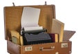 Old brown suitcases with old retro typing machine on white background