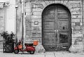 Old Brown Vespa against Old buildings Royalty Free Stock Photo