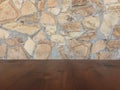 Old brown wood table with blurred stone block wall in light room background Royalty Free Stock Photo