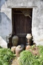 Old brown wooden door with rice wine jars outside. Wuzhen, Tongxiang, China. Royalty Free Stock Photo