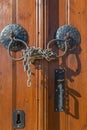 Old brown wooden door handles,chain and lock Royalty Free Stock Photo