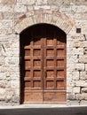 Old brown wooden door in medieval street Royalty Free Stock Photo