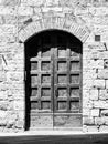 Old brown wooden door in medieval street Royalty Free Stock Photo