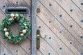 Old brown wooden door with vintage handle and decorations Royalty Free Stock Photo