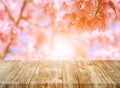 Old brown wooden plank with blurred pink flower nature backgrounds