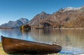 Old brown wooden rowboat on a mountain lake shore in the Swiss Alps Royalty Free Stock Photo