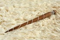 Wool white yarn and old wooden spindle close-up.