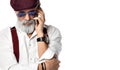 Old brutal senior millionaire man in cap talking on the mobile phone in aviator sunglasses