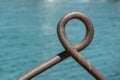 Old bucket handle by the water Royalty Free Stock Photo
