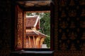 Old Buddha hall seen thorugh window at Wat Xieng thong, Luang Prabang - Laos Royalty Free Stock Photo