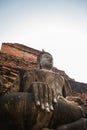 Old buddha statue in ancient temple with evening scene