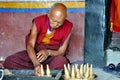 Old Buddhist monk preparing butter sculptures