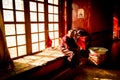 An old Buddhist monk sitting in the window Lhasa Tibet