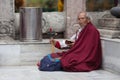 The old Buddhist pilgrim, rotates a small wheel Royalty Free Stock Photo