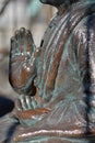 Old Buddhist statue holding coins Royalty Free Stock Photo